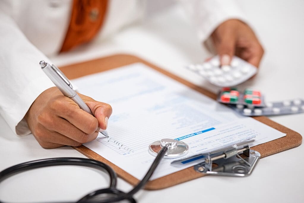 A Doctor checks the prescription of health insurance covered medication